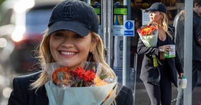 Rita Ora carries a bouquet of flowers as she runs errands in Tesco - www.msn.com
