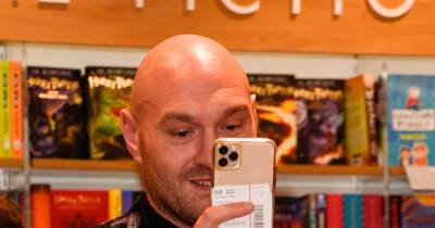 Tyson Fury wears a suit covered in his own face as he surprises fans by turning up to wife Paris' book signing - www.manchestereveningnews.co.uk