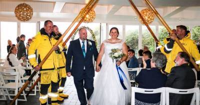 Lifeboat rescuers race from colleague's wedding to save paddleboarders stranded on beach - www.manchestereveningnews.co.uk - Manchester
