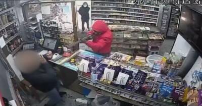 Armed with a shotgun and a knife, this is the terrifying moment two masked men raided an off-licence - www.manchestereveningnews.co.uk