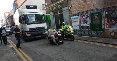 Moment angry mobility scooter driver 'holds up 10 cars' after refusing to pull over while waiting for his chippy - www.manchestereveningnews.co.uk - Manchester