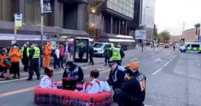 Police swoop on COP26 protestors blocking busy Glasgow road in 'blood-soaked' rubber dingy - www.dailyrecord.co.uk - city Santander