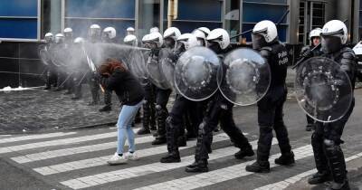Belgian police use tear gas and water cannon as protesters march against Covid restrictions - www.manchestereveningnews.co.uk - Belgium - city Brussels
