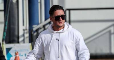 Stephen Bear arrives at police station with stuffed toy pig on leash as he answers his bail - www.ok.co.uk - Britain - Dubai