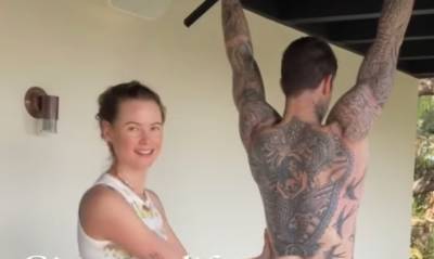 Behati Prinsloo Helps Spot Adam Levine During His Shirtless Workout at Home - www.justjared.com