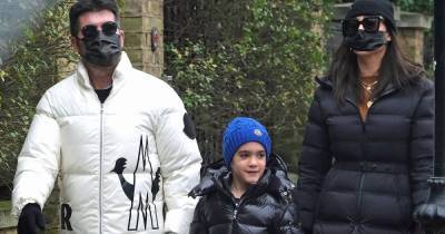 Simon Cowell's son Eric looks so grown up as family wrap up for walk to mark his 7th birthday - www.ok.co.uk - Britain - London - city Holland, county Park