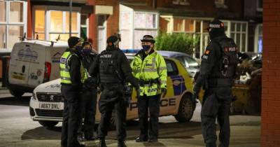 'There were seven or eight coppers and they all had guns': Armed police storm Manchester street and 'kick front door in' after 'shots fired at house' by balaclava-clad thugs - www.manchestereveningnews.co.uk