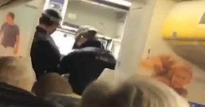 'I'm going to smash your head in': Moment man arrested after headbutting cabin crew on Ryanair flight - he had downed vodka before launching rampage - www.manchestereveningnews.co.uk - Manchester