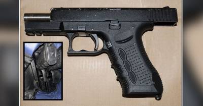 Man arrested after police find two loaded guns during raid in Acoats - www.manchestereveningnews.co.uk - Manchester