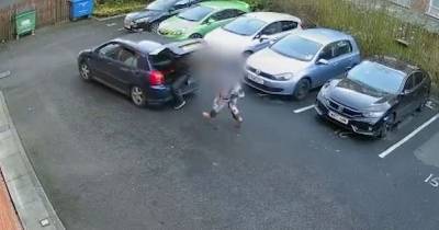 WATCH: Shocking video shows woman dragged along by car after confronting gang of masked men stealing catalytic converter - www.manchestereveningnews.co.uk