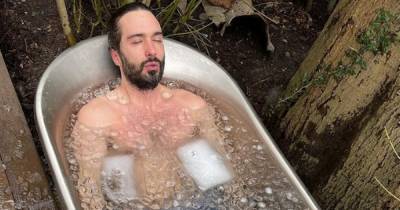 Topless Joe Wicks soaks in outdoor bath filled with ice despite snow falling - www.ok.co.uk - Britain - Netherlands