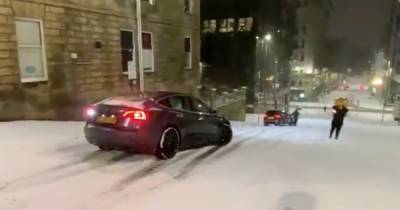 Storm Darcy: Tesla smashes into parked car after sliding down snowy Glasgow street - www.dailyrecord.co.uk - Scotland - Centre - city Glasgow, county Centre