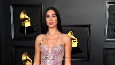 Dua Lipa on the 'Symbolism' Behind Her 2021 GRAMMYs Look and 'Nuts' 6 Nominations (Exclusive) - www.etonline.com - Britain