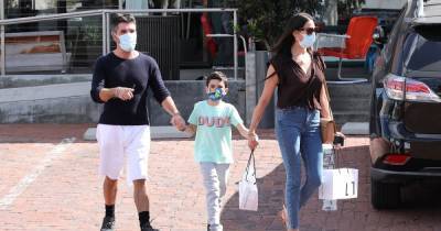 Simon Cowell enjoys family day out as he holds hands with lookalike son Eric and partner Lauren Silverman - www.ok.co.uk - Britain - California