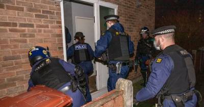 Five arrests, £10k of drugs, cash and a gun - police storm homes in dawn raids across Manchester - www.manchestereveningnews.co.uk - Manchester