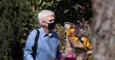 Phillip Schofield carries bouquet of flowers on 28th wedding anniversary a year after coming out as gay - www.ok.co.uk