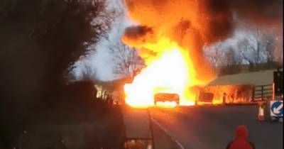 Dramatic footage shows two cars burst into explosive fireball after crashing on Scots road as hero cop runs towards inferno - www.dailyrecord.co.uk - Scotland