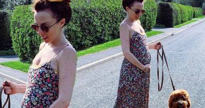 EastEnders' Louisa Lytton tenderly cups her baby bump on a dog walk - www.msn.com