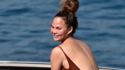 Chrissy Teigen, 35, Slays In Plunging Purple Swimsuit On Vacation With John Legend Kids - hollywoodlife.com