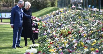 Charles and Camilla view flowers left in memory of Prince Philip in their first joint outing since his death - www.manchestereveningnews.co.uk