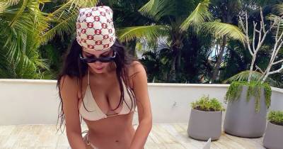 Kim Kardashian Studies for Law School in Teeny Bikini— and It’s Giving Us Elle Woods Vibes - www.usmagazine.com