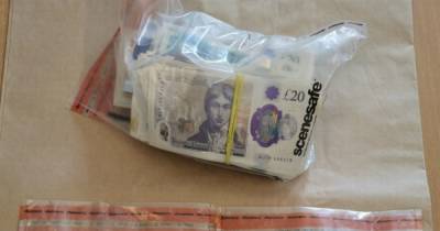 Police uncover thousands in cash and 'uncut Class A drugs' after raid at Wigan home - www.manchestereveningnews.co.uk
