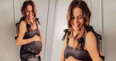 Pregnant Binky Felstead displays her growing bump in silk dress - www.msn.com