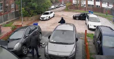 CCTV captures brazen thieves dancing as they steal catalytic converter from car - www.manchestereveningnews.co.uk