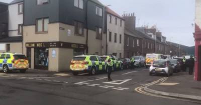 Armed police called to ‘ongoing incident’ in Scots town as officers lockdown street - www.dailyrecord.co.uk - Scotland - county Ferry
