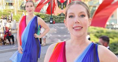 Katherine Ryan covers her baby bump in a chic colourful striped dress - www.msn.com
