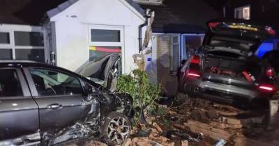 Two cars smash into family homes in scary late-night crash - www.manchestereveningnews.co.uk