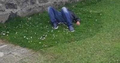Moment Scots council workers cut grass around man passed out on ground - www.dailyrecord.co.uk - Scotland
