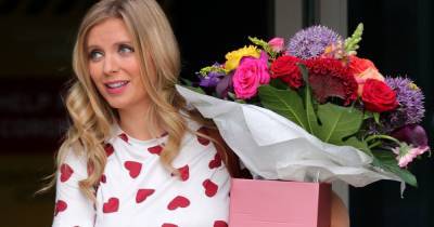 Rachel Riley shows off baby bump in heart patterned top as she carries flowers - www.ok.co.uk