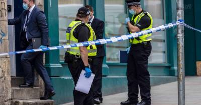 Dozens of cops swarm Edinburgh property in morning raid as street locked down - www.dailyrecord.co.uk