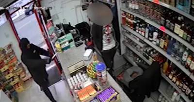 "Get your f****** money out": Terrifying CCTV footage shows thug threatening cashier at knifepoint for till money... for the SECOND day in a row - www.manchestereveningnews.co.uk