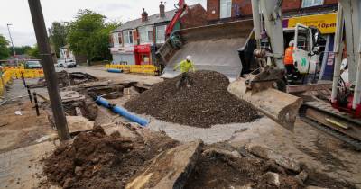 Pictures show huge hole in road after burst water main caused flooding - www.manchestereveningnews.co.uk - Manchester