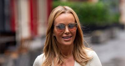Amanda Holden goes braless as she wows in white flare jeans and low-cut top combo - www.ok.co.uk - Britain