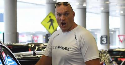 Tyson Fury looks tense as he heads back to UK with pregnant wife Paris and 5 kids - www.ok.co.uk - Britain