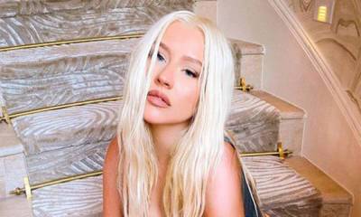Christina Aguilera causes a stir posing topless in tiny briefs - hellomagazine.com