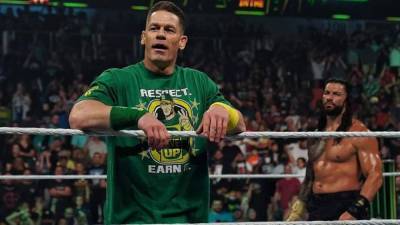 John Cena Makes Epic Return to WWE, Confronts Roman Reigns Ahead of SummerSlam - www.etonline.com