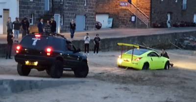 Man charged with 'number of road offences' after car gets stuck in sand at Scots beach - www.dailyrecord.co.uk - Scotland