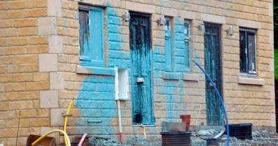 Vandals daub blue paint across new homes under construction - www.manchestereveningnews.co.uk