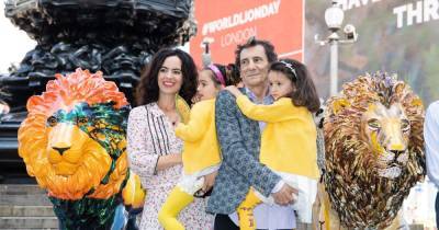 Rolling Stone Ronnie Wood cuddles twins Alice and Gracie, 5, on family outing - www.ok.co.uk - London