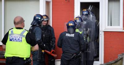 The signal is given... and the front door is smashed: Moment police raid a home in force’s ‘largest ever’ crackdown on organised crime groups and drug gangs - www.manchestereveningnews.co.uk - county Cheshire