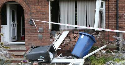 Emergency services descend on street after car smashes into house - www.manchestereveningnews.co.uk