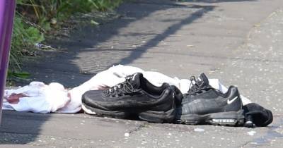 Blood-stained clothes and trainers lie in street of Glasgow shooting as victim fights for life - www.dailyrecord.co.uk - city Milton