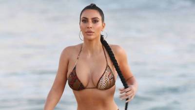 Kim Kardashian Sizzles In Tiny Gold Bikini As She Launches Nude Suede Fragrance — See Pics - hollywoodlife.com