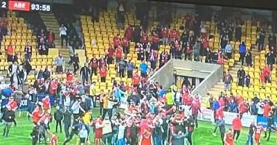 Watch as dozens of Aberdeen fans invade pitch to celebrate injury time winner at Livingston - www.dailyrecord.co.uk - county Livingston