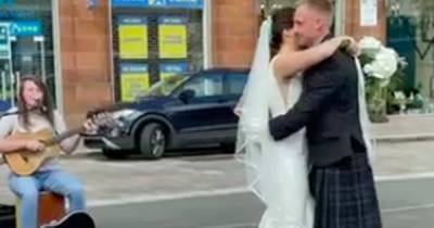 Emotional video captures Scots newlyweds' first dance alongside busker in Glasgow street - www.dailyrecord.co.uk - Scotland - city Merchant