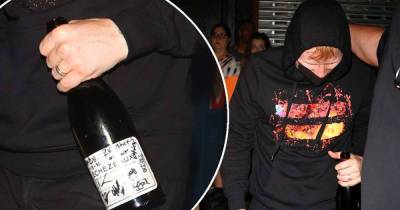 Ed Sheeran clutches a £2600 bottle of wine as he leaves NYC party - www.msn.com